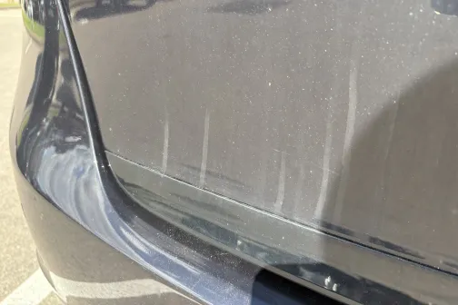 Putekļains automa&scaron;īnas spārns saules gaismā.