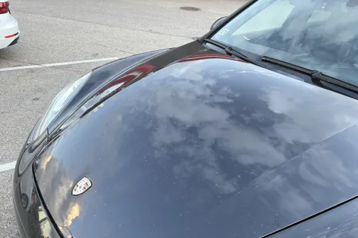 Auto pārsegs atspoguļo mākoņus.