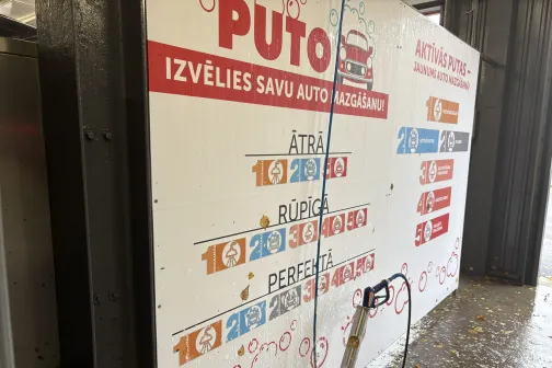 Uz sienas norāde ar auto mazgā&scaron;anas veidiem.