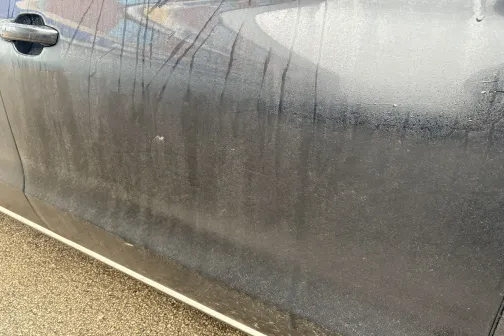 Netīras automa&scaron;īnas durvis ar ūdens &scaron;vīkām.