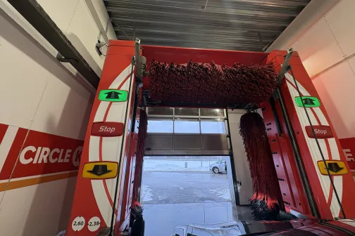 Automazgātuves iekārta ar sarkaniem tīrī&scaron;anas birstēm.