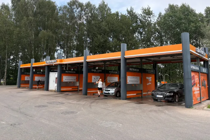 Āra automazgātava ar vairākiem mazgā&scaron;anas boksiem oranžā krāsā.